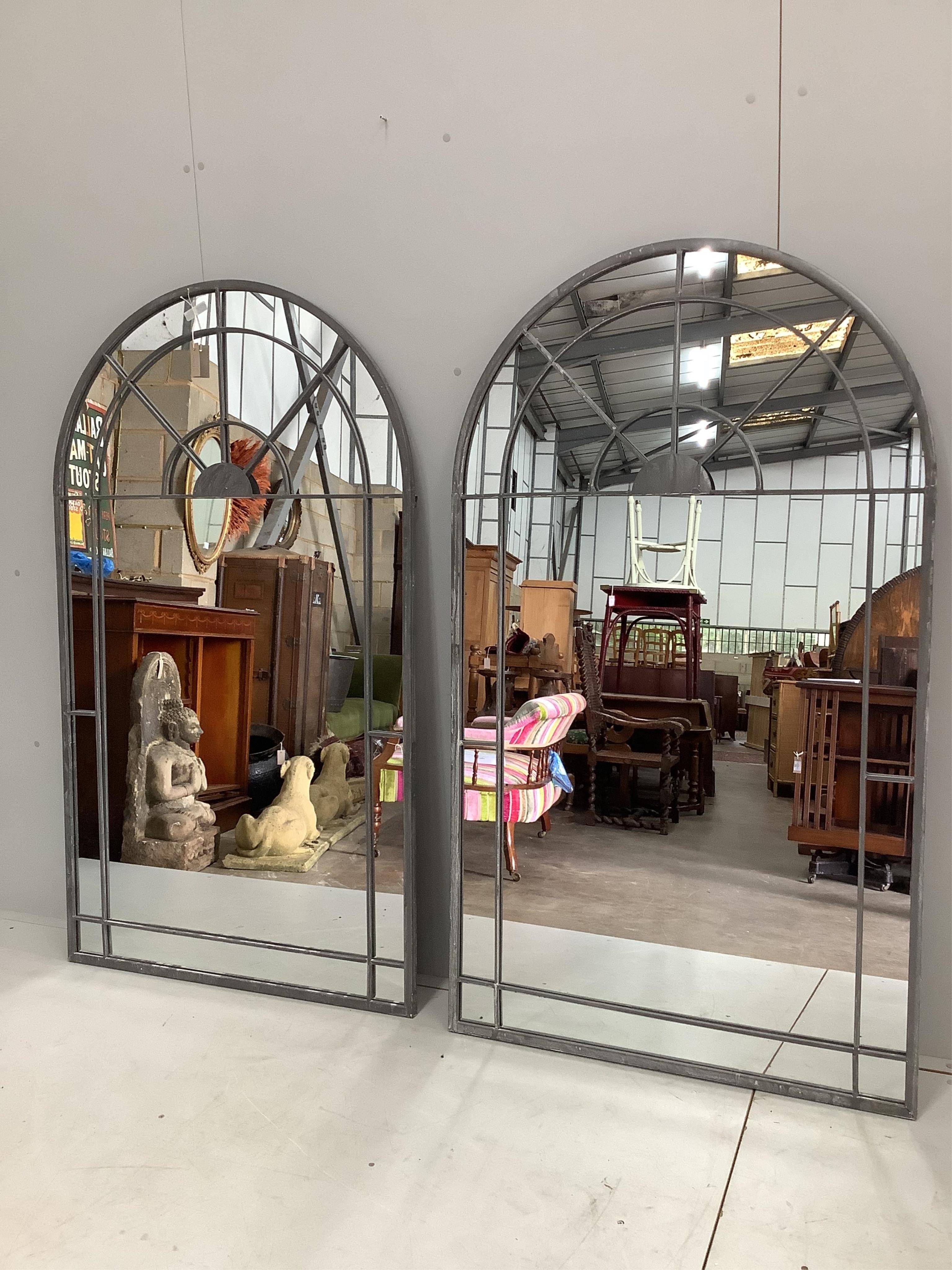 A pair of wrought iron framed window style garden mirrors, each width 90cm, height 156cm. Condition - good